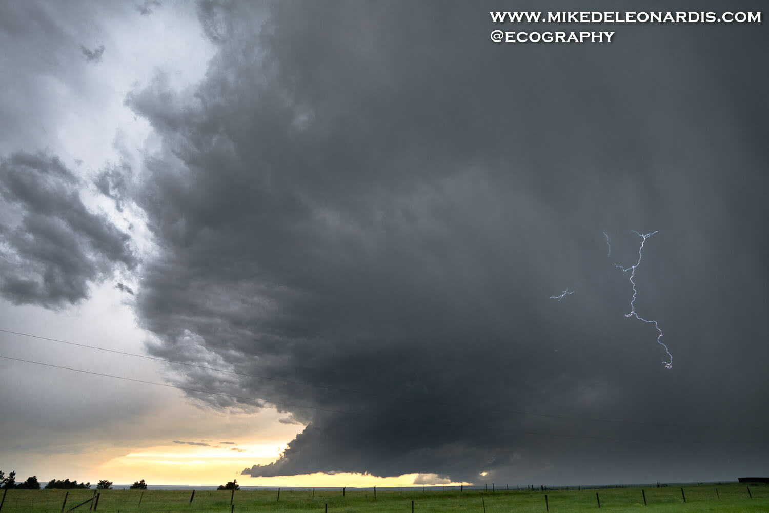 Nebraska Panhandle - In the Nebraska Panhandle this spring day, the storms erupted in the evening. As the National Weather Service put it, â€œOne of the most significant outbreaks of severe weather to impact southeast Wyoming and the western Nebraska Panhandle in the past 30 years occurred on the afternoon and eveningâ€. As the first storm passed over me and cleared the sky I was able to get this shot. There was a nice EF-2 tornado on the right side of this behind those huge dark clouds. I thought this picture came out nice, but it wasnâ€™t until a few weeks later when I was initially going through the shots for the first time that I noticed there was a stray lightning bolt in this shot.
