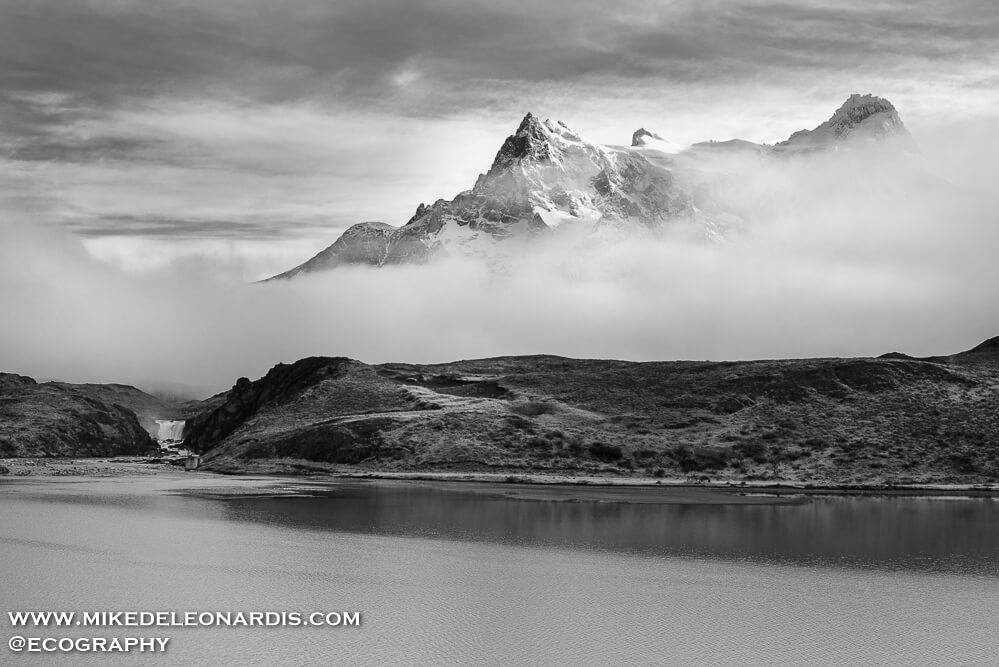 Torres del Paine National Park, Chile - Bordering Pehoe Lake is the Salto Grande waterfall which is a definitely a sight to see in Torres Del Paine National Park. The waterfall looks miniscule compared to the towering mountains behind it.