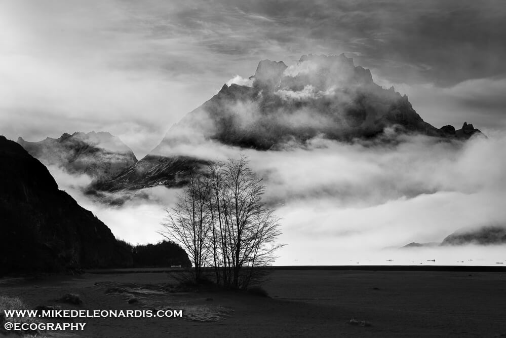 Torres del Paine National Park, Chile - The whole day was foggy, snowing, and with low visibility. As I was leaving the area I happened to turn around and see the clouds clearing just enough for this picture. The clouds were so thick beforehand that I had no idea this huge mountain was hiding behind the clouds.<br>